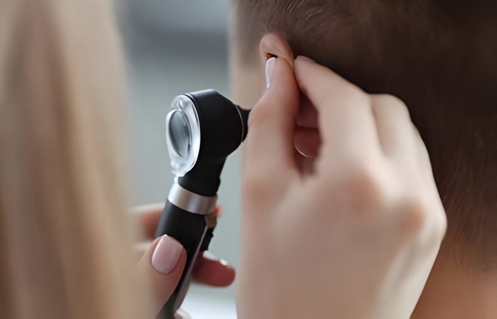 Ear specialist in Dubai examining ear using otoscope