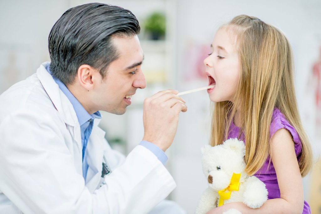 Pediatric ENT doctor examining a child patient