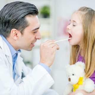 Pediatric ENT doctor examining a child patient
