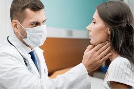 Voice and throat specialist diagnosing vocal cord conditions